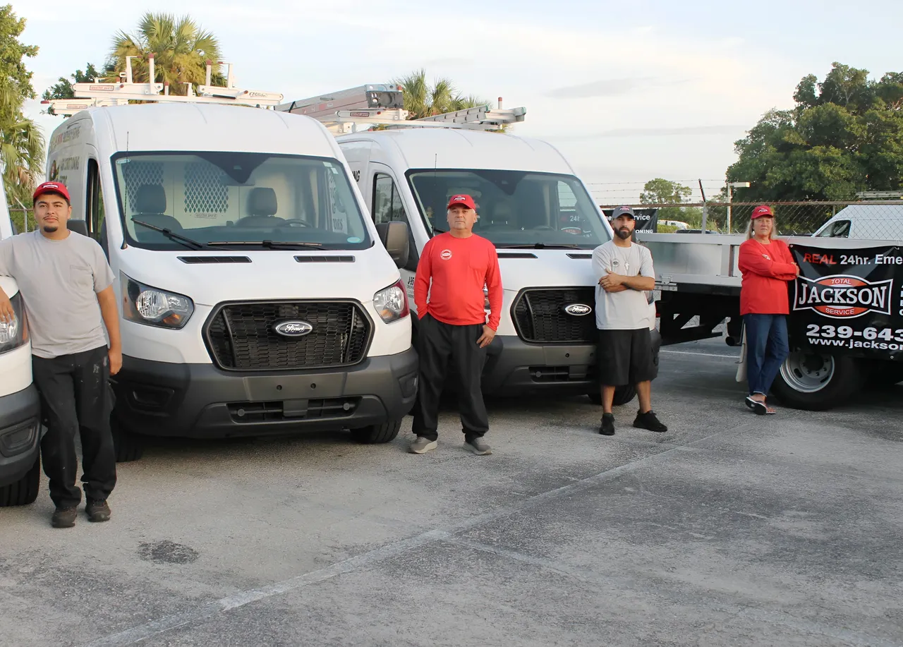 Jackson Total Service crew members standing with the fleet at dawn