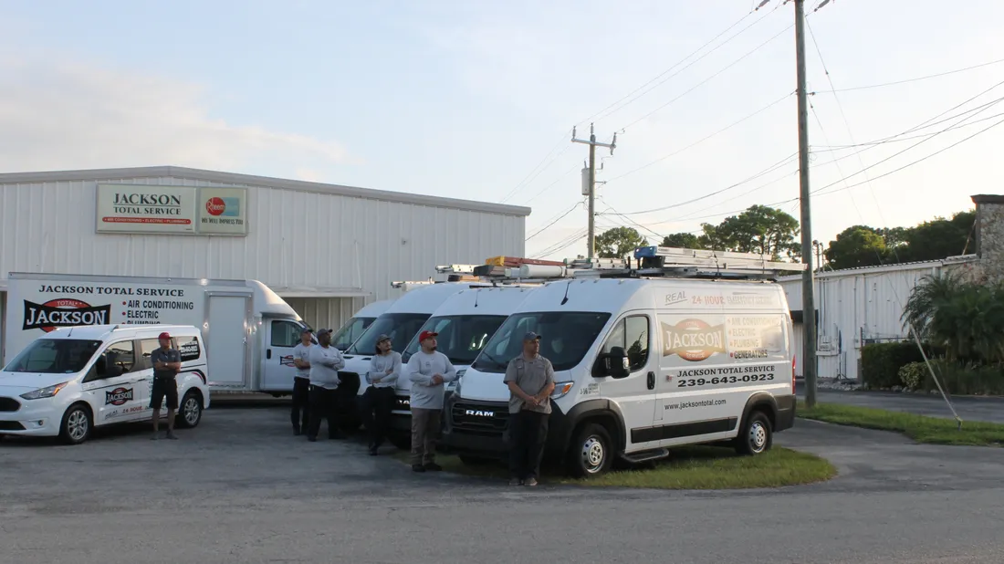 The Jackson Total Service crew and vans outside the Naples headquarters at sunrise