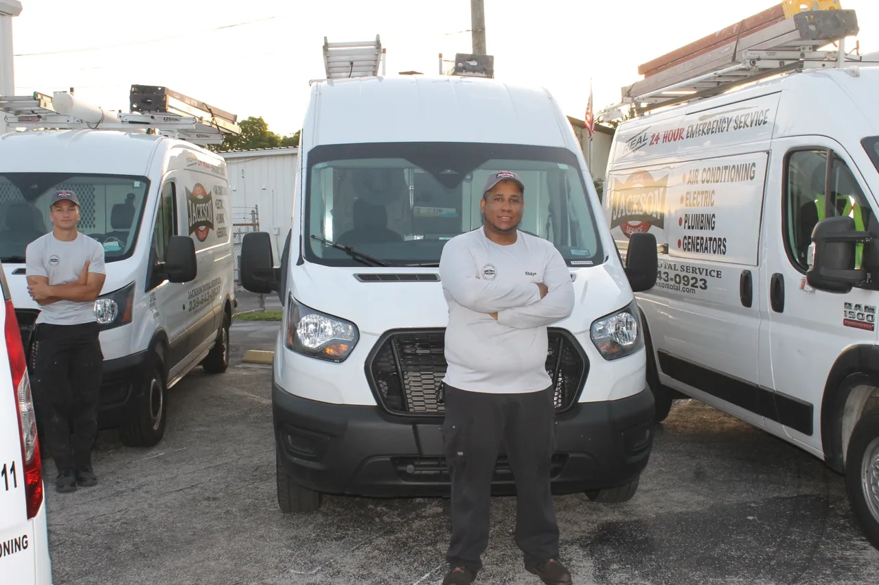 Jackson Total Service technician standing in front of his Ford Transit service van