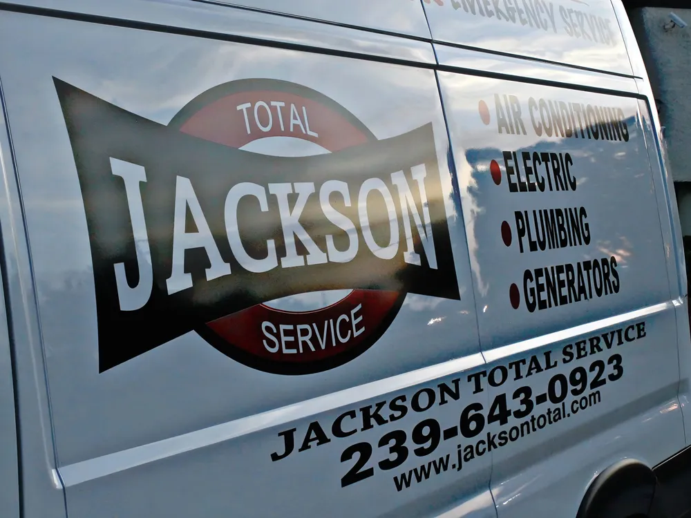 The Jackson Total Service bowtie badge on the side of a service van